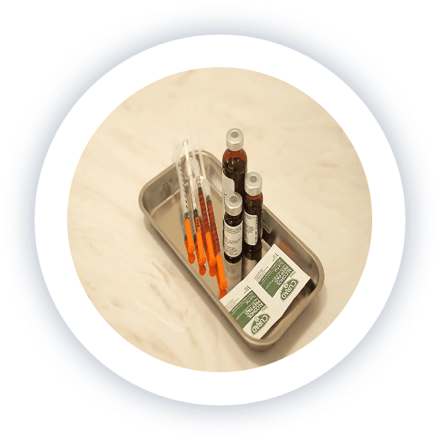 Sterile injection supplies on a medical tray at a medical clinic in Edina, Minnesota, including syringes, medication vials, and alcohol prep pads prepared for patient treatment.